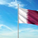 Qatar flag on flagpole waving cloudy sky background realistic 3d illustration with copy space